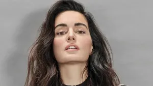 Ana De La Reguera Striking A Pose In Front Of A Red Background Wallpaper