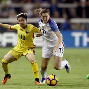 Andi Sullivan Playing Soccer In The Field Showing Phenomenal Skills. Wallpaper