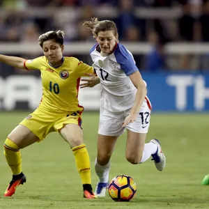 Andi Sullivan Playing Soccer In The Field Showing Phenomenal Skills. Wallpaper