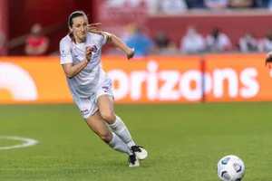 Andi Sullivan Posing On Soccer Field Wallpaper