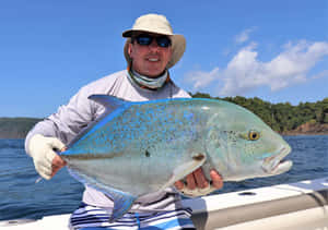 Anglerwith Blue Runner Fish Wallpaper