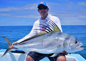 Anglerwith Roosterfish Catch Wallpaper