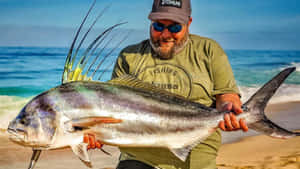 Anglerwith Roosterfish Catch Wallpaper