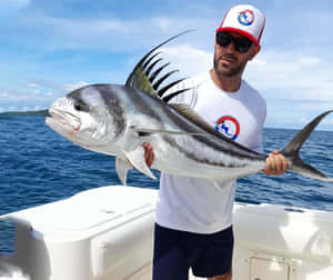 Anglerwith Roosterfish Catch Wallpaper