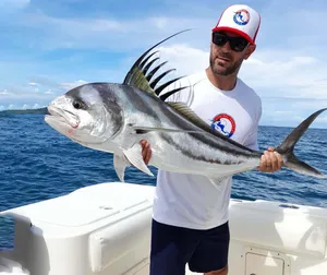 Anglerwith Roosterfish Catch Wallpaper