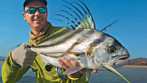 Anglerwith Roosterfish Catch Wallpaper
