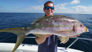 Anglerwith Yellowtail Snapper Catch Wallpaper