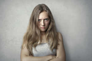 Angry Young Woman Arms Crossed.jpg Wallpaper