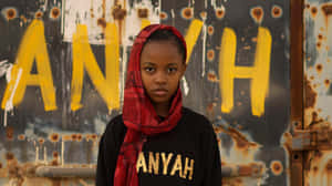 Aniyah Portrait Against Yellow Graffiti Wallpaper