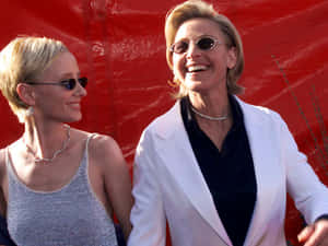 Anne Heche Having A Delightful Time With A Friend Wallpaper