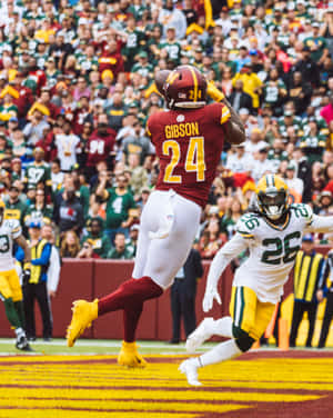 Antonio Gibson Catching Football In Game Wallpaper