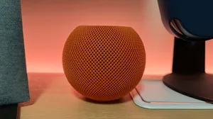 Apple Homepod On Wooden Table Wallpaper