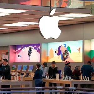 Apple Store Interiorwith Customersand Displays Wallpaper