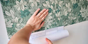 Applying Wallpaper With Wrist Visible Wallpaper