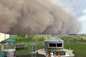 Approaching Dust Storm Over Residential Area Wallpaper