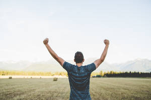 Arms Raised Of Excited Man Wallpaper