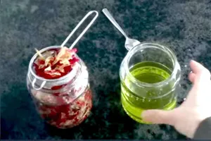 Aromatic Rose Essential Oil Dripping Into A Glass Bottle Wallpaper