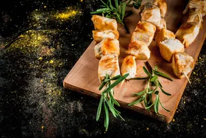 Aromatic Rosemary With Succulent Kebabs On Chopping Board Wallpaper