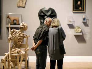 Art Gallery S A_ Couple Admiring Exhibits Wallpaper