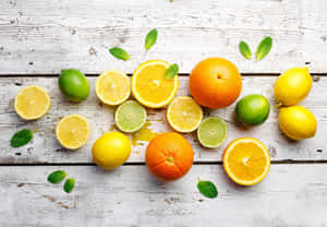 Assorted Citrus Fruitson Wooden Background Wallpaper