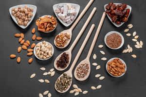 Assorted Nutsand Seedson Spoonsand Bowls Wallpaper