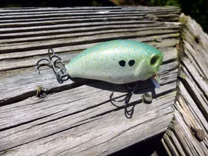 Assortment Of Colorful Fishing Bait On A Wooden Table Wallpaper