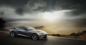 Aston Martin Db9 - Luxury Sports Car In Action Wallpaper