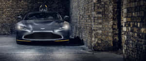 Aston Martin Vantage Cruising On The Open Road Wallpaper