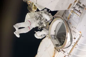 Astronaut Performing A Spacewalk On A Space Mission Wallpaper