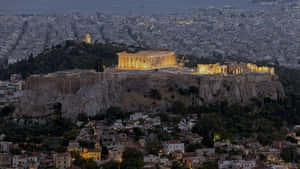 Athenian Acropolis With Yellow Accent Lights Wallpaper