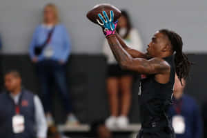 Athlete Catching Football During Drill Wallpaper