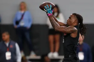 Athlete Catching Football During Drill Wallpaper