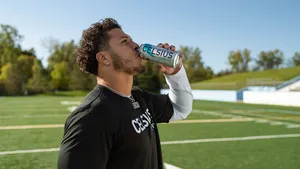 Athlete Drinking Celsius On Field Wallpaper