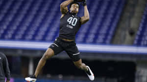 Athlete Jeremy Chinn Leaping Catch Wallpaper