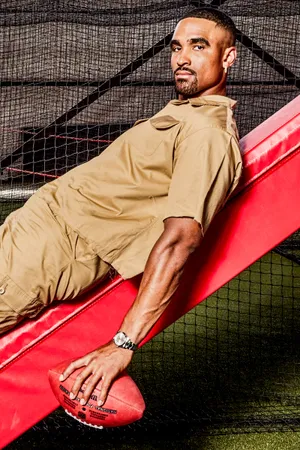 Athlete Relaxed Posewith Football Wallpaper