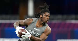 Athlete Running With Football During Combine Wallpaper