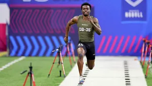 Athlete Running40 Yard Dashat Combine Wallpaper