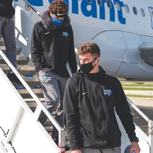 Athletes Disembarking Airplane Wallpaper