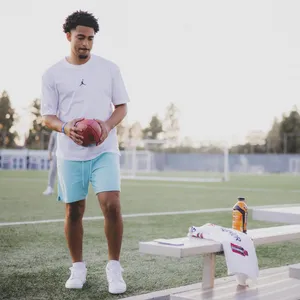 Athletewith Footballon Field Wallpaper