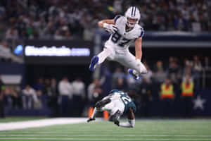 Athletic Football Catch Midair Wallpaper