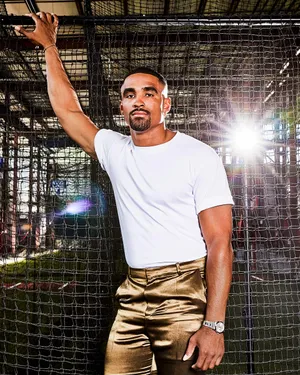 Athletic Man Posingin Golden Pants Wallpaper