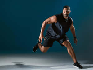 Athletic Man Running Pose Wallpaper