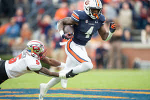 Auburn_ Running_ Back_ Evades_ Tackle.jpg Wallpaper