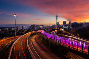 Auckland Sky Towerand Highwayat Dusk Wallpaper