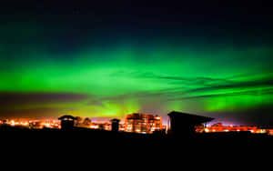 Aurora Australis Over Cityscape Wallpaper