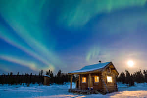 Aurora Borealis Over Wooden Cottage Wallpaper