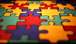Autism Puzzle Pieces On A Table Wallpaper