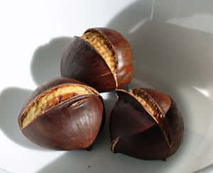 Autumn Chestnut On A Wooden Surface Wallpaper