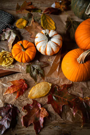 Autumn Pumpkinsand Fallen Leaves Wallpaper