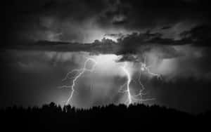 Awe-inspiring Black And White Storm Clouds Over A Vast Landscape Wallpaper